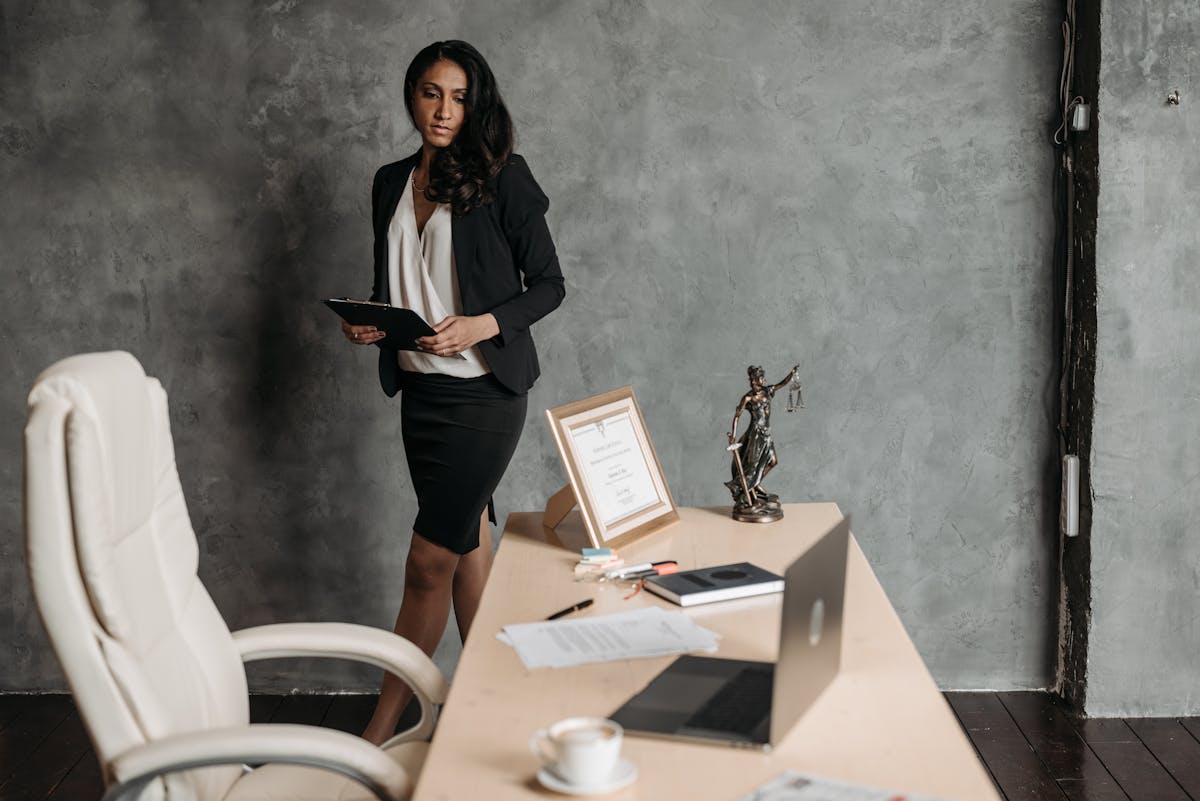 Woman Standing near Desk in Office