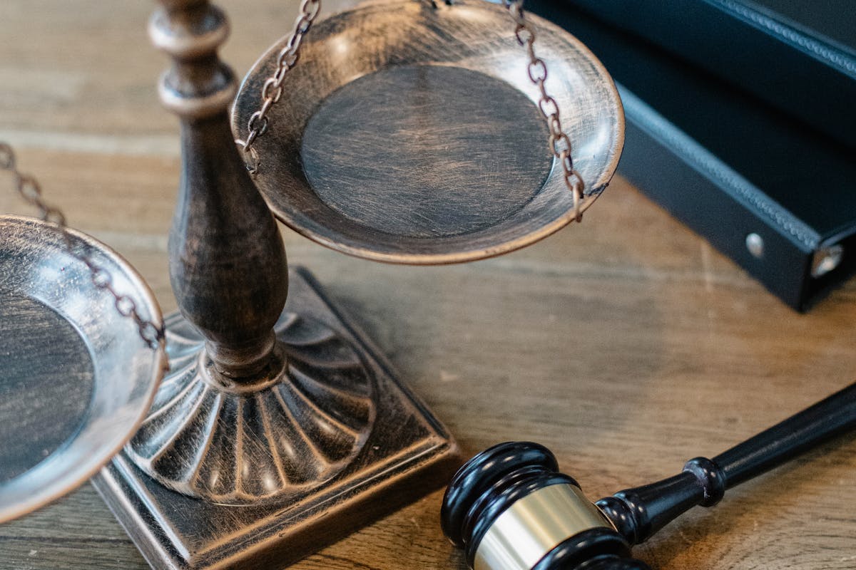 Justice Scales and Gavel on Wooden Surface