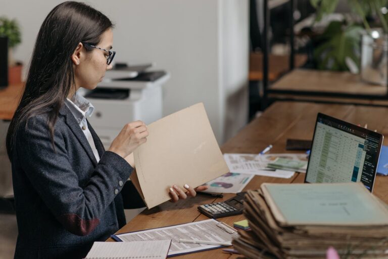 Woman Holding a Brown Folder while Working in the Office