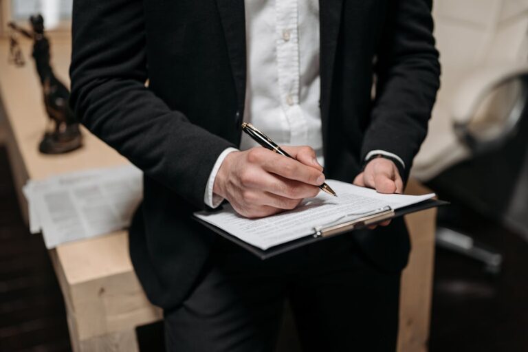 Close Up Photo of a Person Holding a Clipboard